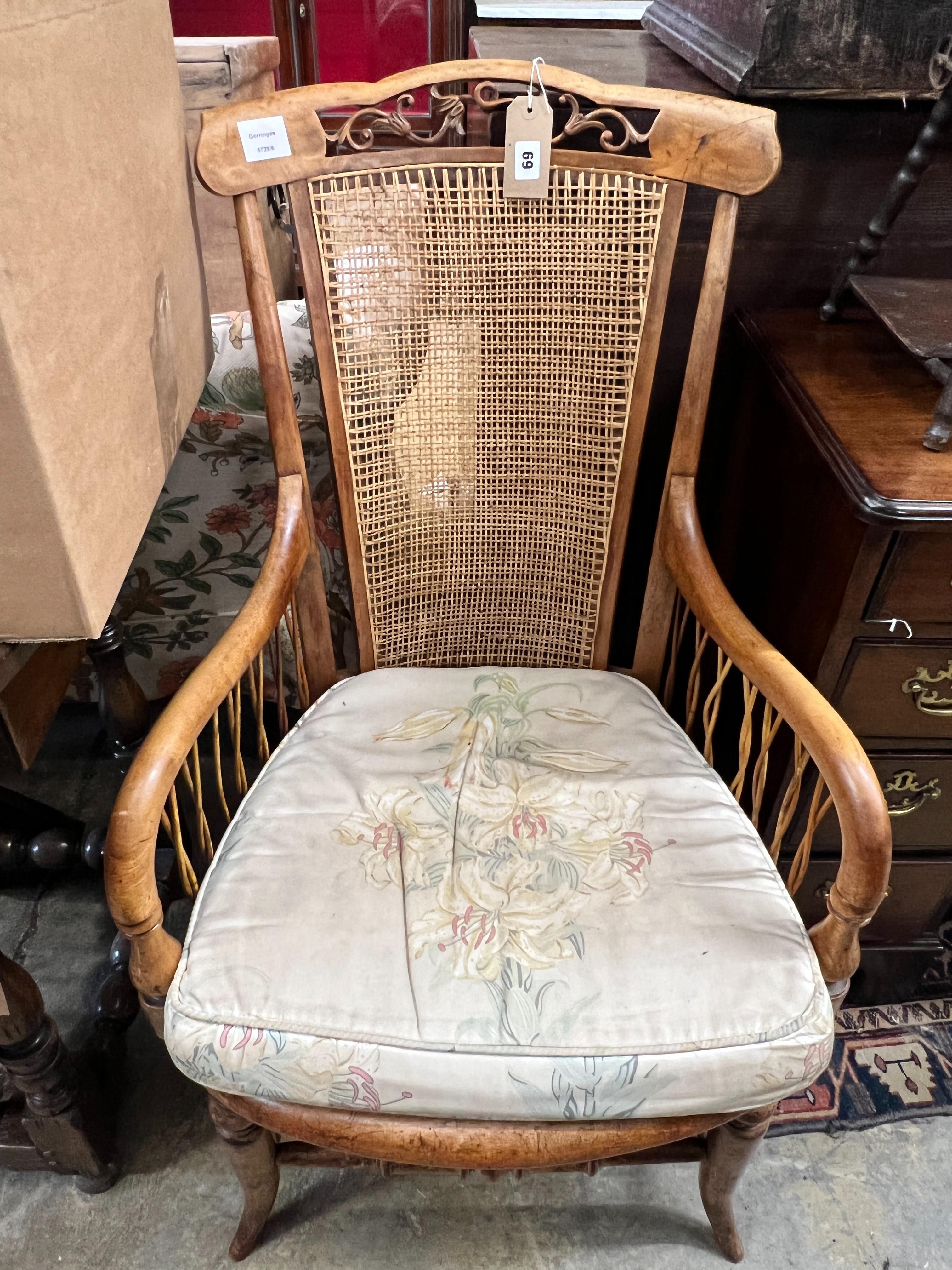 A Victorian maple framed caned back armchair